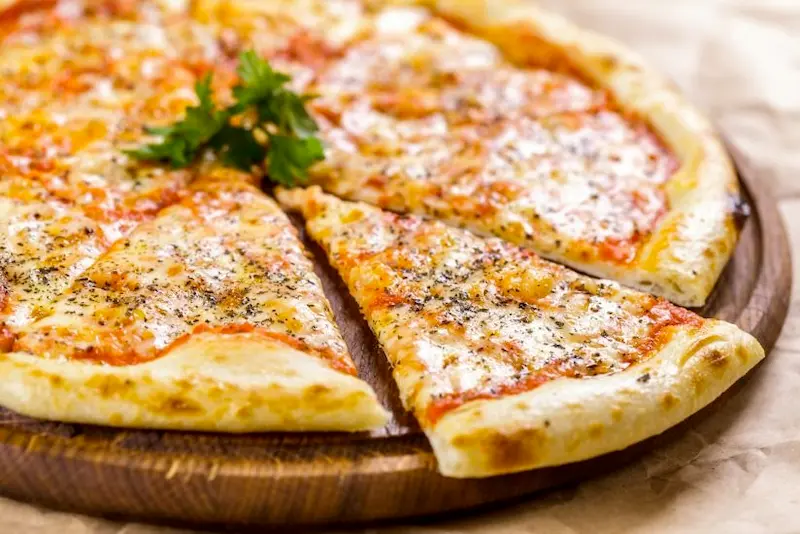 plain cheese kosher pizza with cilantro garnish in the middle